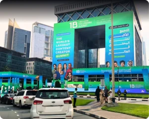 Luxury vehicles arriving at the 1 Billion Followers Summit venue in Dubai with event branding and city skyline in the background