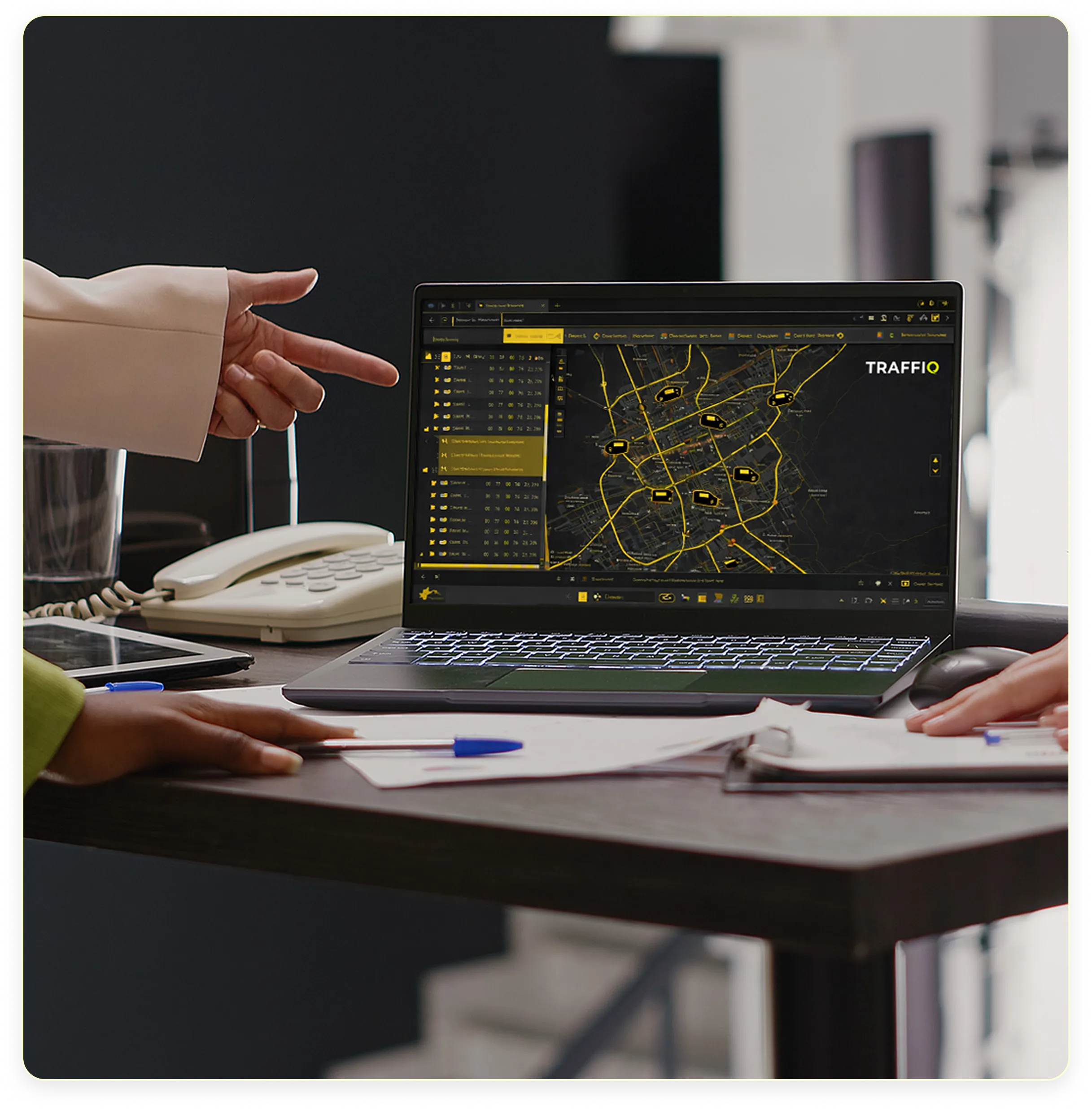 Laptop screen displaying the TraffiQ platform monitoring vehicles and event transport fleet in real time for live operations.