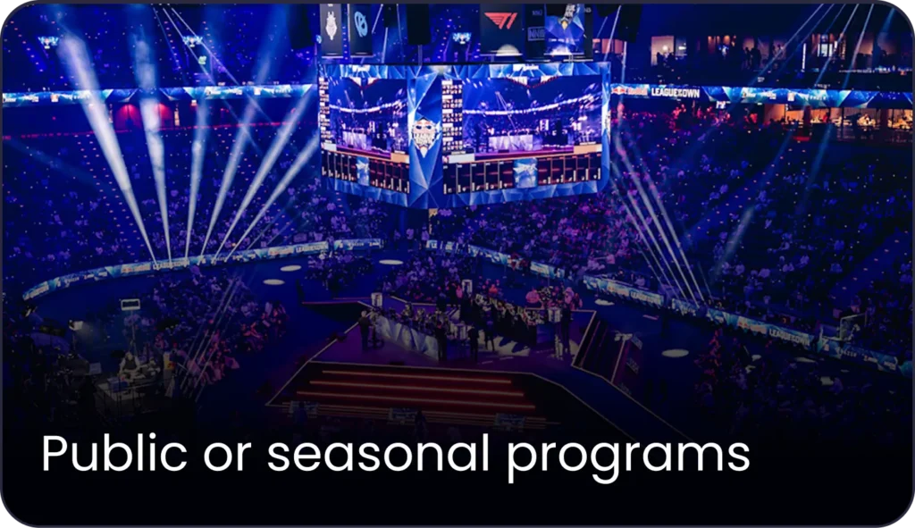 Large crowd attending a public event in UAE in an arena with blue stage lights
