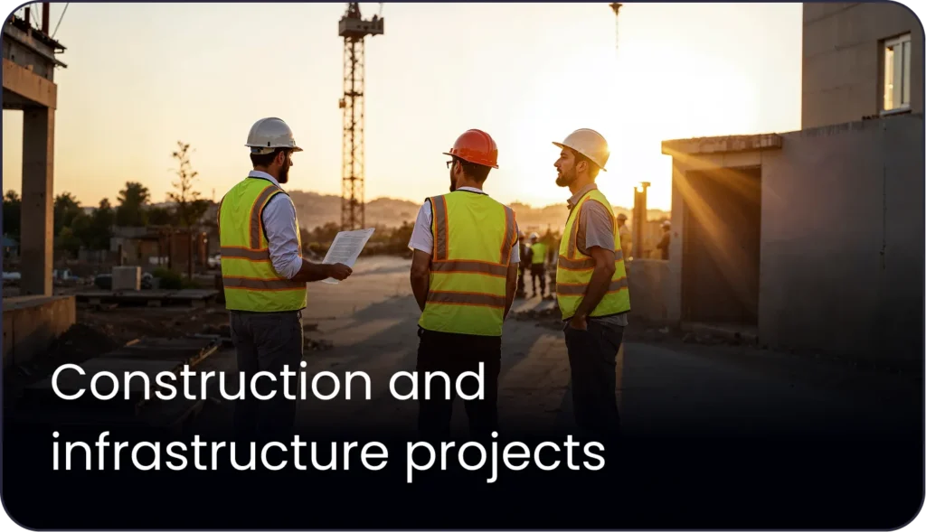 TraffiQ Parking startegists in hard hats and safety vests discussing plans at a Middle East project site