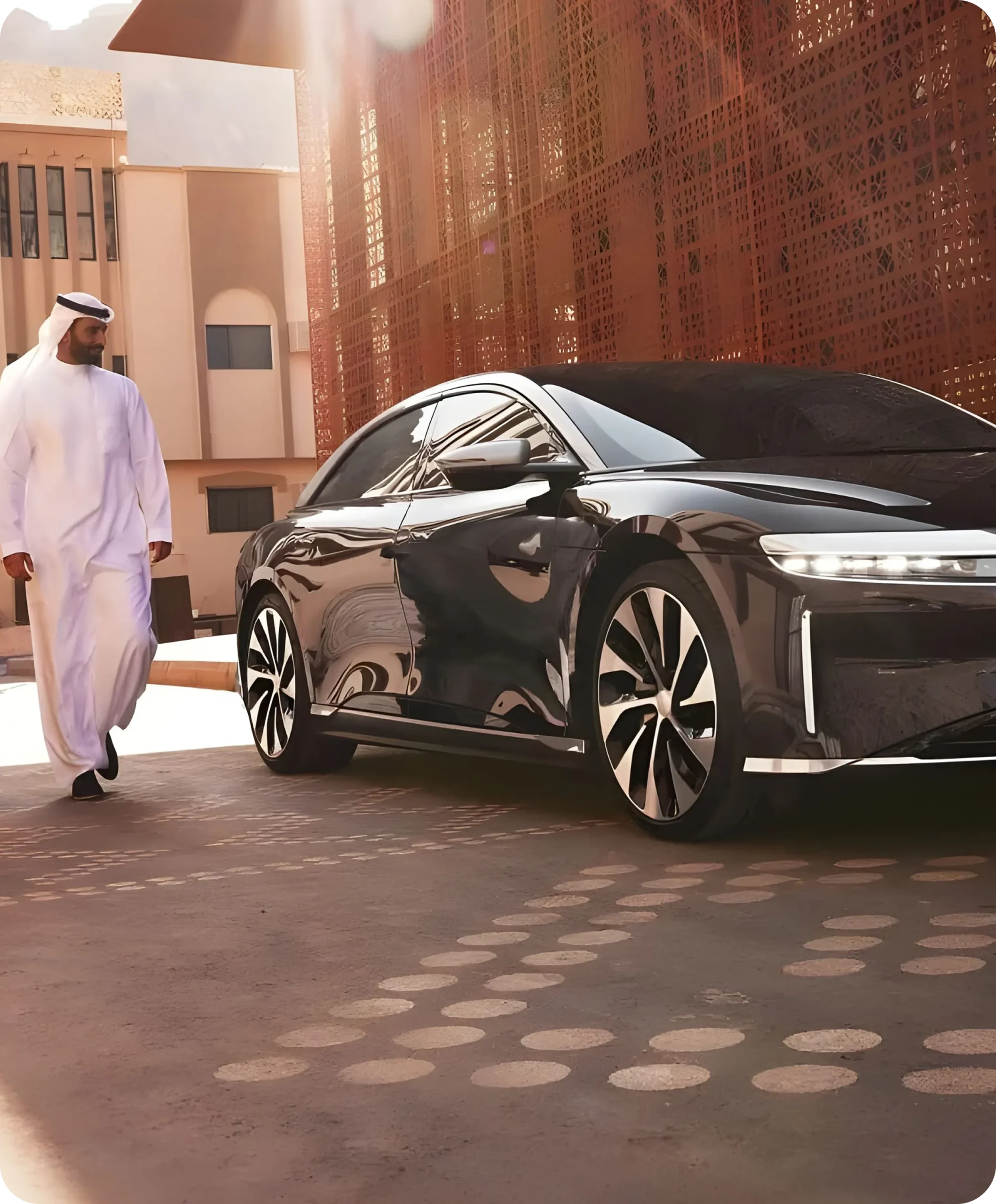TraffiQ VVIP guest services representative walking next to a black Lucid Air luxury electric vehicle in the Middle East.